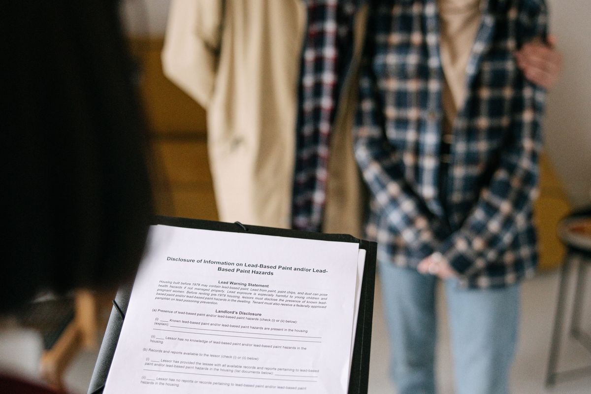 Landlord reviewing a prospective tenant's rental paperwork and screening